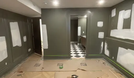Calgary suite masked with floor protection part-way through an interior repaint