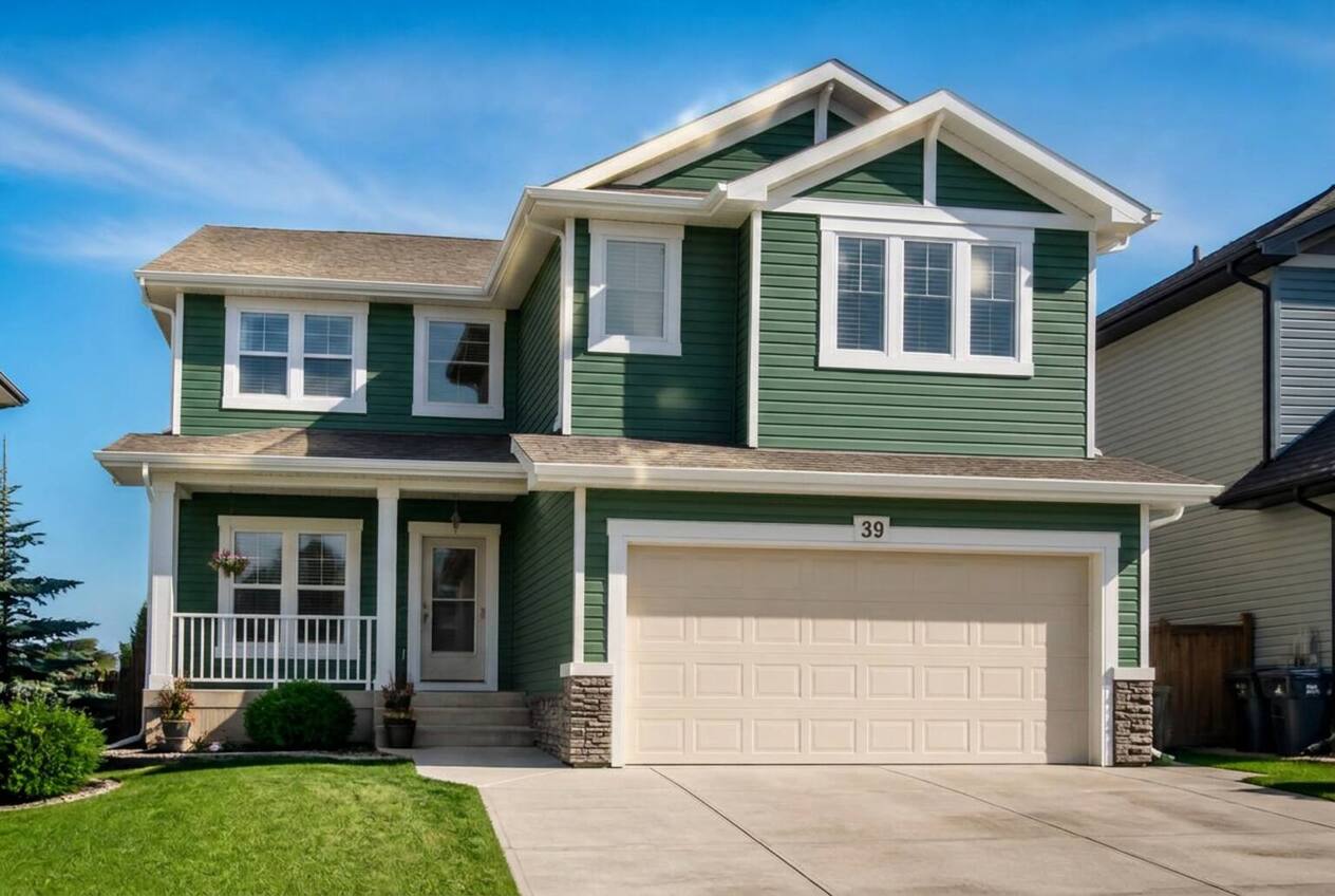 The same house with siding repainted in Deep Juniper