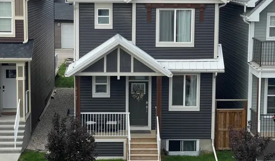 Charcoal-sided Calgary home photographed on a clear summer day