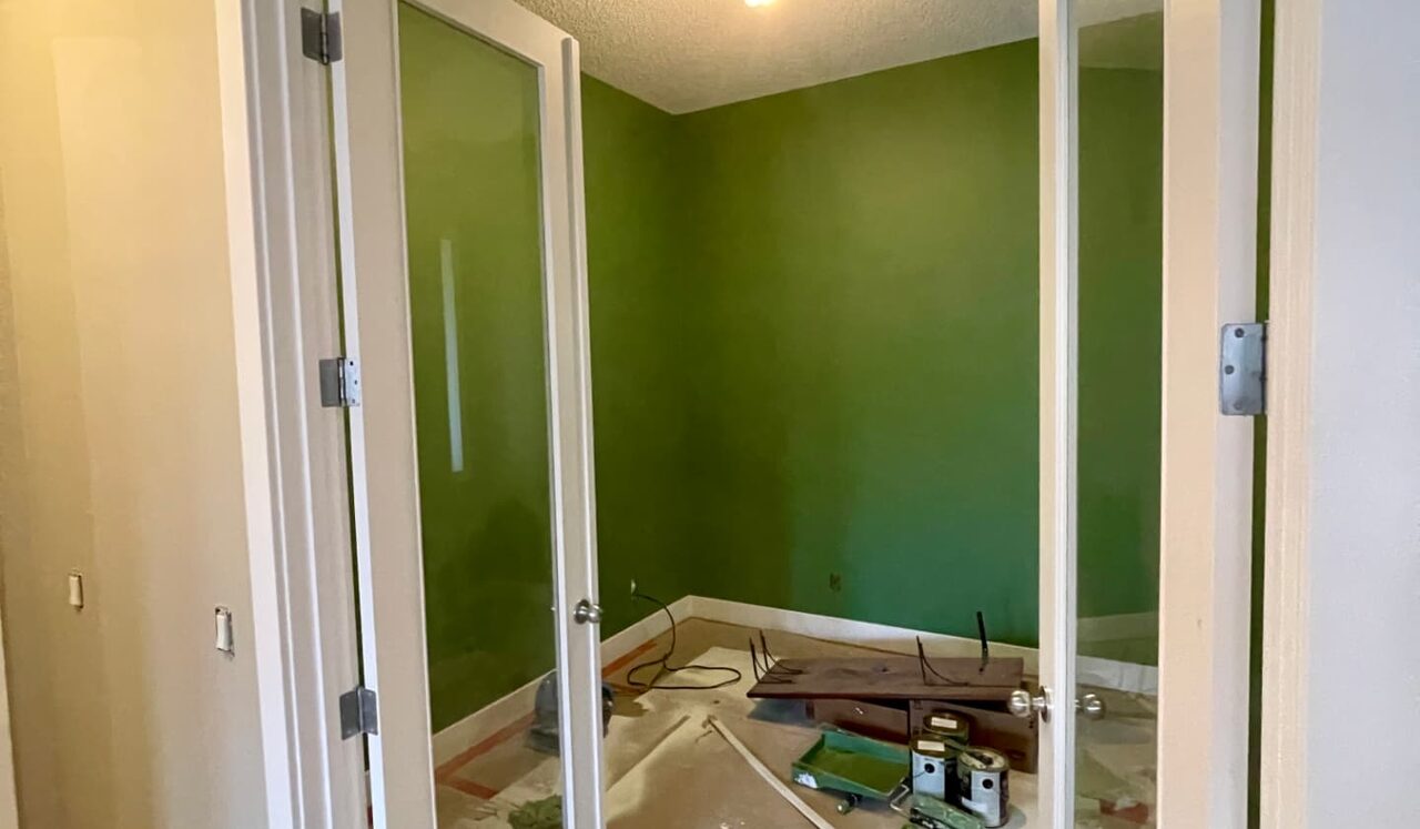 Green office painted behind glass French doors in a Calgary home